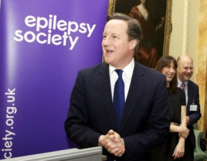 All smiles for the camera has he plots to cut the benefits of those with epilepsy